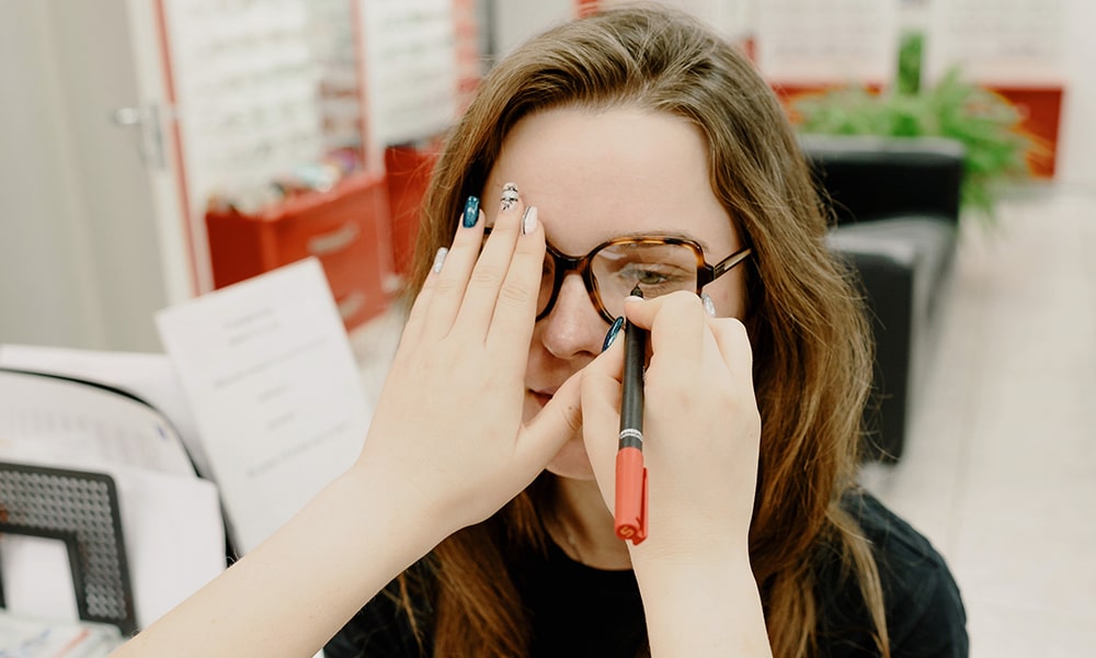 doctor examining girl's eyes