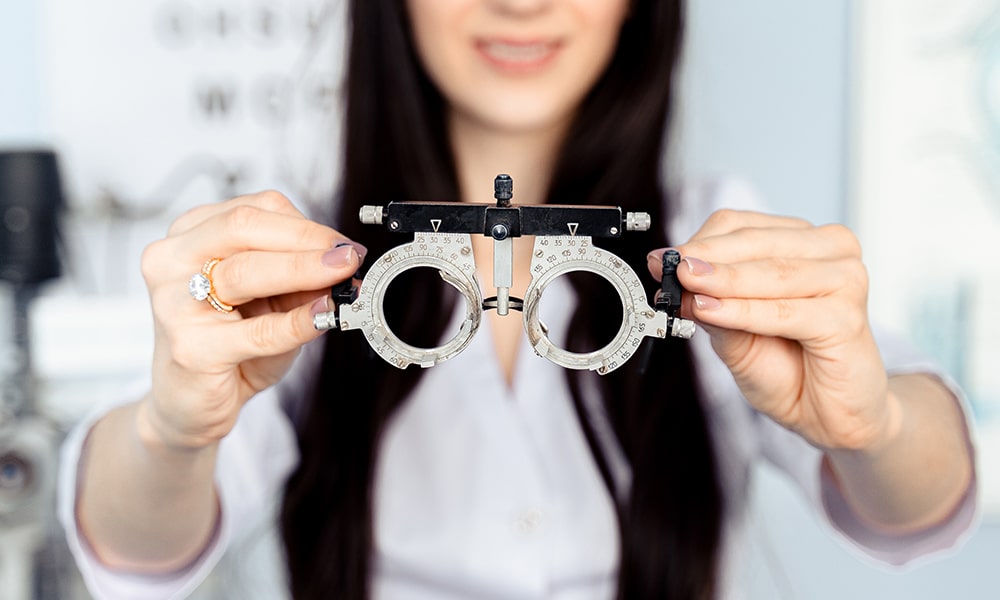 optometrist holding glasses